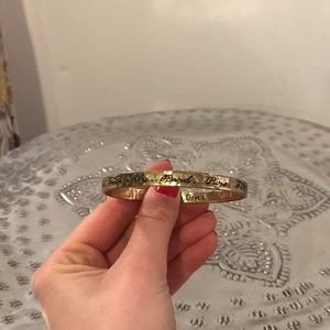 Waxing Poetic hammered gold “Love” bangle